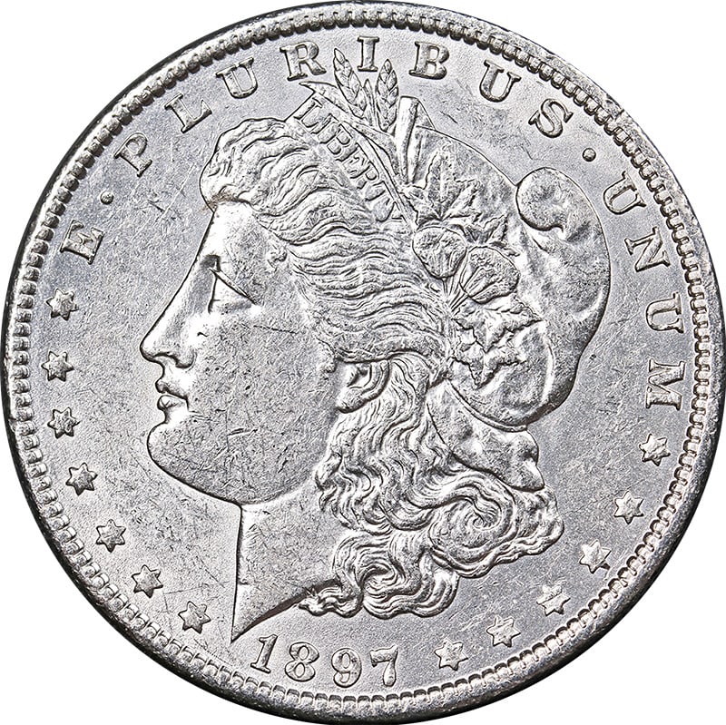 1897-O Morgan Silver Dollar Choice AU/BU 90% Silver Coin: 1897-O Morgan Silver Dollar Choice AU/BU 90% Silver Coin This 1897-O Morgan Silver Dollar is a remarkable piece of numismatic history. Featuring a stunning profile of Liberty adorned with a wreath, th