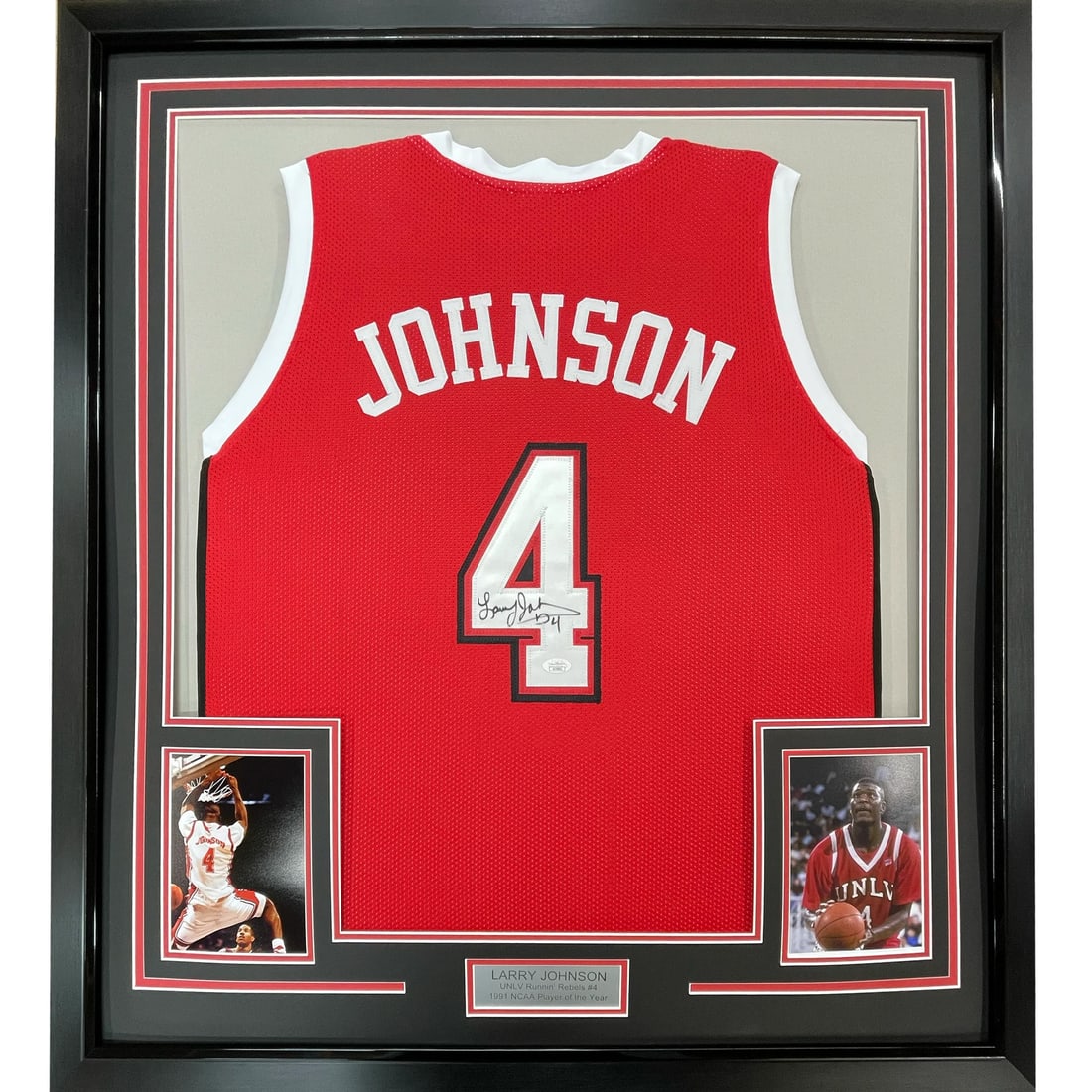 FRAMED Autographed LARRY JOHNSON 33x42 UNLV Red Jersey PSA/DNA COA: FRAMED Autographed LARRY JOHNSON 33x42 UNLV Red Jersey PSA/DNA COA This stunning framed basketball jersey features the iconic Larry Johnson, number 4, from the UNLV Rebels. The jersey is autographed b