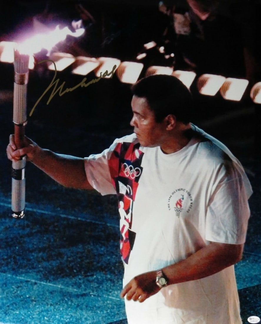 Muhammad Ali Autographed 16x20 Olympic Torch Photo JSA Certified: Muhammad Ali Autographed 16x20 Olympic Torch Photo JSA Certified Capture a piece of history with this Muhammad Ali signed 16X20 photo, featuring the legendary boxer holding the Olympic torch during th