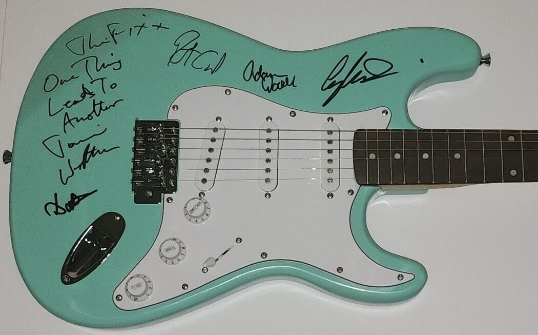 The Fixx Band Signed Guitar x5 Cy Curnin Jaime West-Oram: The Fixx Band Signed Guitar x5 Cy Curnin Jaime West-Oram This is a pre-owned electric guitar signed by members of The Fixx Band, including Cy Curnin and Jaime West-Oram. It features a striking mint gr