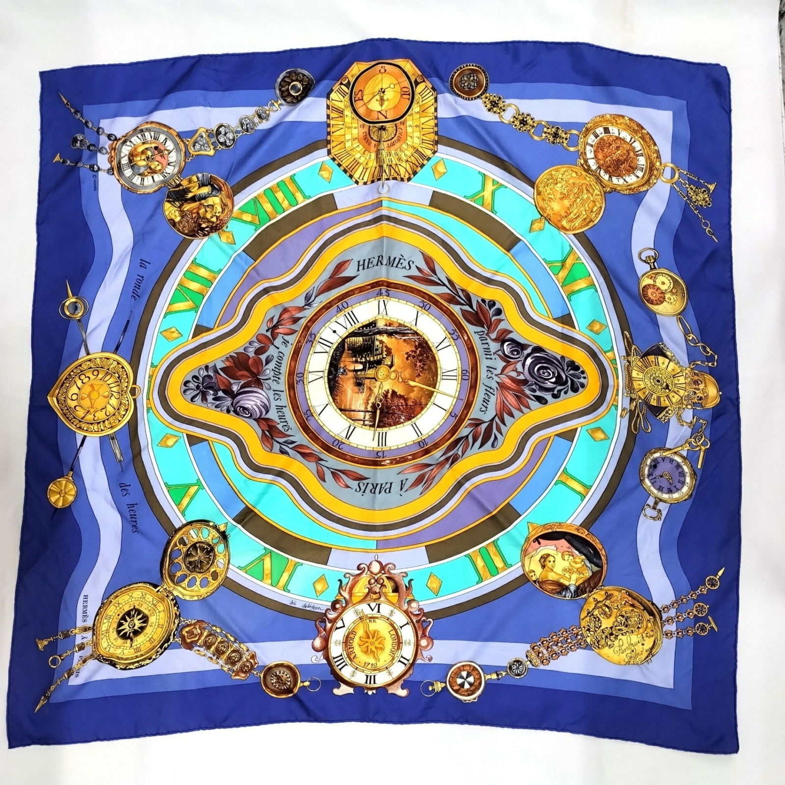 Hermes Silk Scarf Time Among Flowers Blue 85cm x 88cm Very Good Condition: Hermes Silk Scarf Time Among Flowers Blue 85cm x 88cm Very Good Condition This exquisite Hermes scarf, titled "Time among flowers," is crafted from 100% silk, showcasing a stunning design that feature