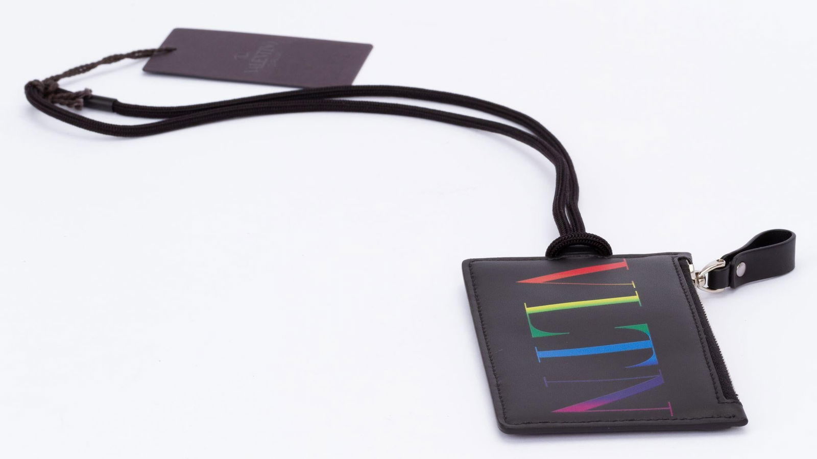 Valentino NIB Card Case with Lanyard: Valentino NIB Card Case with Lanyard This stylish card case by Valentino features a sleek black design complemented by a vibrant logo, perfect for adding a touch of elegance to your everyday essential