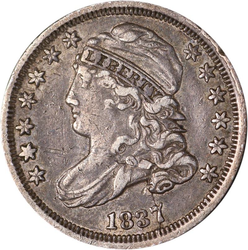 1837 Circulated Silver Bust Dime with Liberty Design: 1837 Circulated Silver Bust Dime with Liberty Design This 1837 Bust Dime is a remarkable piece of numismatic history. Featuring a profile of a woman with the word 'LIBERTY' above her head and stars su