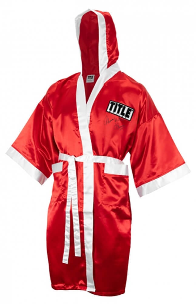 Thomas Hearns Signed Red Boxing Robe w/Hitman Inscription: Thomas Hearns Signed Red Boxing Robe w/Hitman Inscription This is a Thomas Hearns signed Title red boxing robe with 'Hitman' inscription. Item comes with a tamper-proof numbered hologram and Certifica