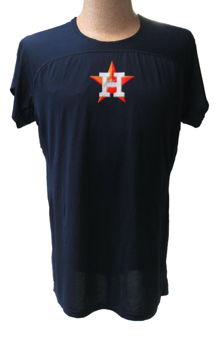 Carlos Correa Autographed Game Worn Batting Practice Shirt: Carlos Correa Autographed Game Worn Batting Practice Shirt This is a pre-owned Carlos Correa autographed batting practice shirt worn during games. The shirt is navy blue and features a distinctive ora