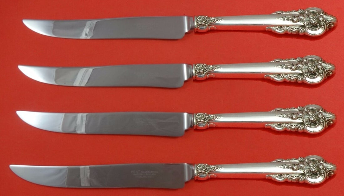 Grande Baroque Sterling Silver Steak Knife Set 4pc Texas Sized: Grande Baroque Sterling Silver Steak Knife Set 4pc Texas Sized Elevate your dining experience with this exquisite 4-piece steak knife set in the Grande Baroque pattern by Wallace. Crafted from sterlin