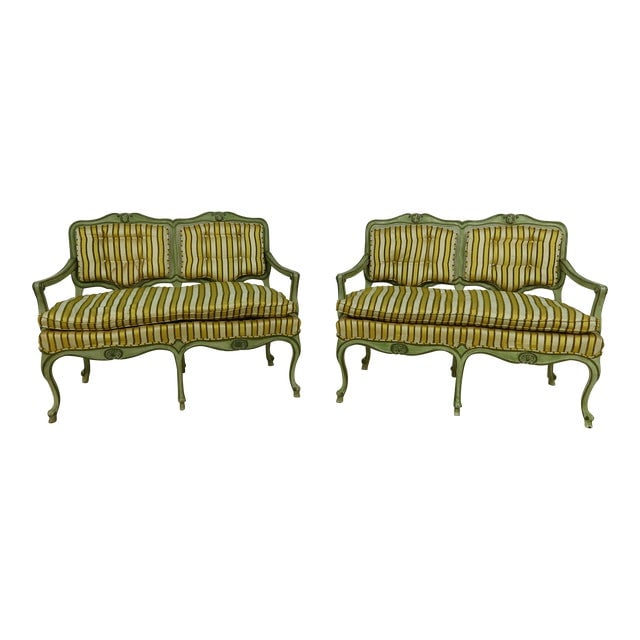 Pair of Venetian Cane Back Upholstered Settees: Pair of Venetian Cane Back Upholstered Settees This stunning pair of Venetian paint-decorated upholstered settees showcases a unique blend of traditional craftsmanship and vintage charm. With a rich h