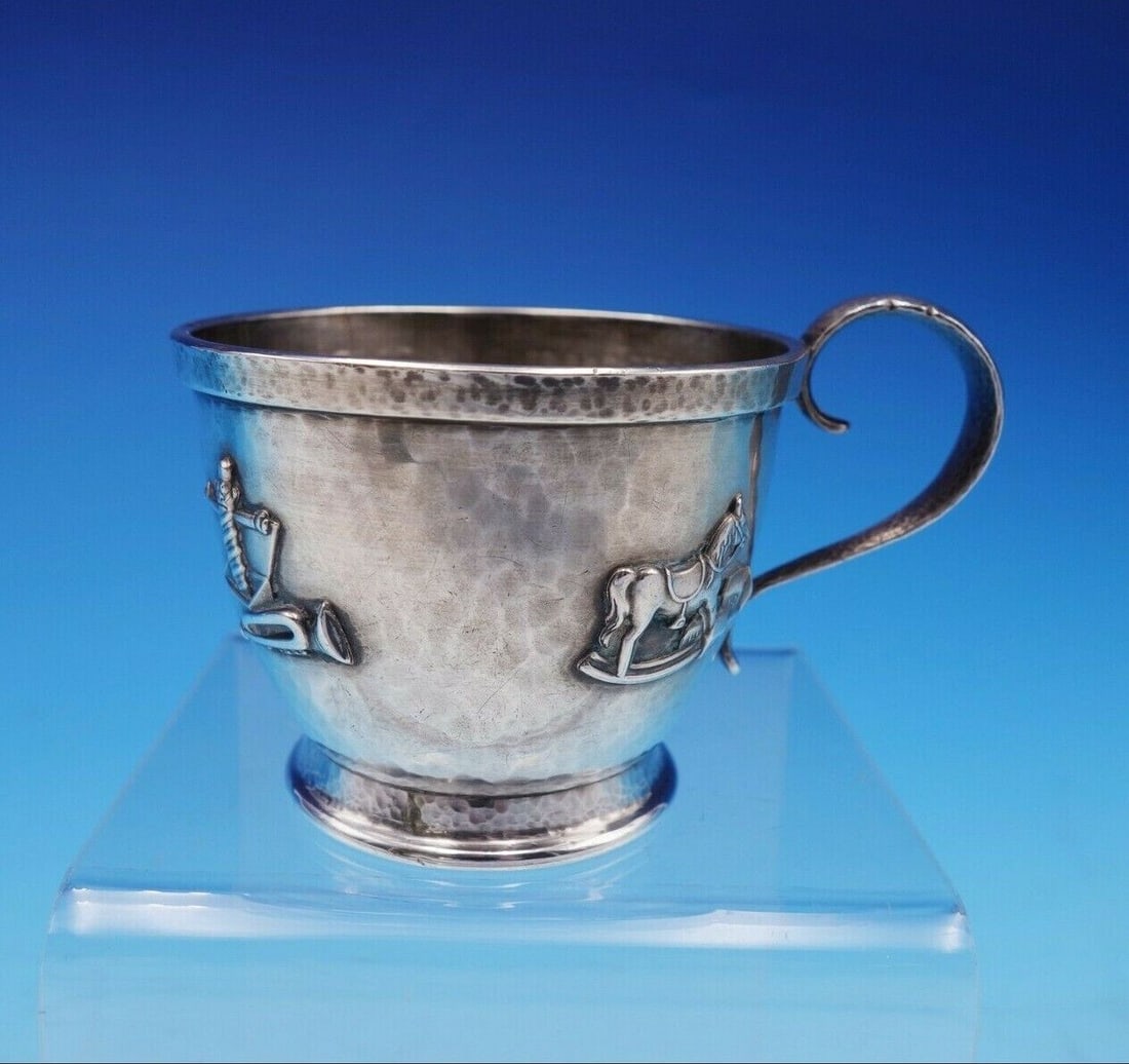 Whiting Sterling Silver Baby Cup Hand Hammered with Toys: Whiting Sterling Silver Baby Cup Hand Hammered with Toys This exquisite Whiting sterling silver baby cup is a charming collectible from the 1900-1940 era. Hand hammered and adorned with delightful app
