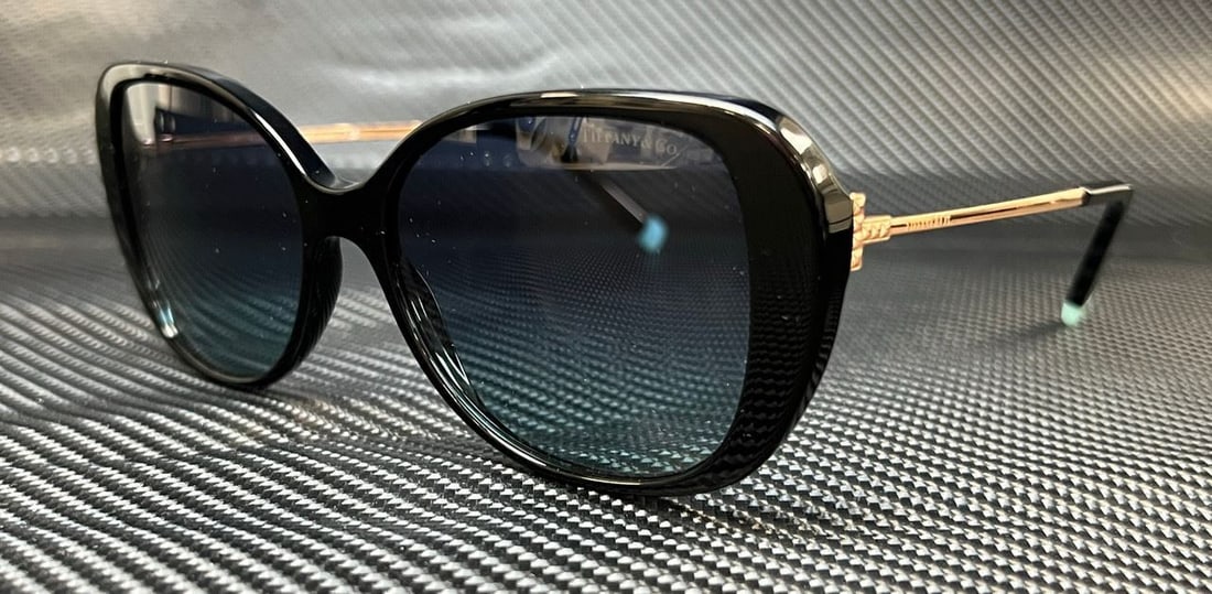 Tiffany & Co. TF4156 Black Blue Gradient Butterfly Sunglasses: Tiffany & Co. TF4156 Black Blue Gradient Butterfly Sunglasses Elevate your style with these Tiffany & Co. TF4156 sunglasses featuring a stunning black frame complemented by blue gradient lenses. Desig