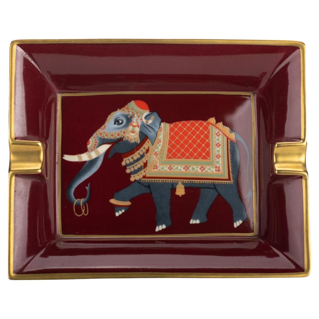 Hermes Burgundy Elephant Ashtray: Hermes Burgundy Elephant Ashtray This exquisite Hermes Elephant Ashtray showcases a stunning burgundy color, accented by a beautifully painted grey elephant adorned with a vibrant blanket. Crafted in