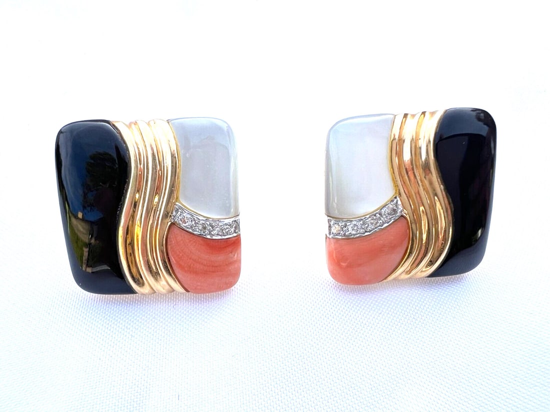 Pair of 14K Yellow Gold Onyx Earrings: Pair of 14K Yellow Gold Onyx Earrings This exquisite pair of earrings showcases a stunning combination of materials including 14K yellow gold, carved coral, mother of pearl, and black onyx. Each earri