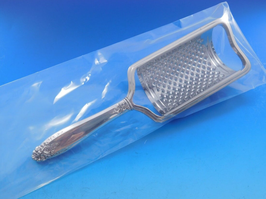 Prelude Sterling Silver Custom Cheese Grater 8 1/2 inches: Prelude Sterling Silver Custom Cheese Grater 8 1/2 inches This exquisite cheese grater showcases the elegant Prelude pattern by International Sterling. Crafted from durable sterling silver, it feature