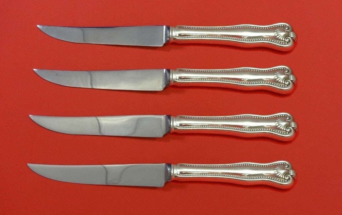 Newport Shell Sterling Silver Steak Knife Set 4 Piece: Newport Shell Sterling Silver Steak Knife Set 4 Piece This exquisite 4-piece steak knife set features a stunning Newport Shell pattern designed by Frank Smith, crafted from high-quality sterling silve
