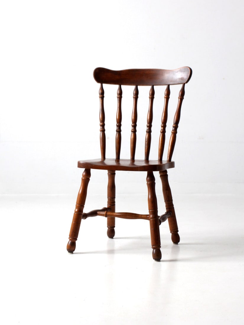 Vintage Lodge Style Spindle Back Dining Chair: Vintage Lodge Style Spindle Back Dining Chair This vintage lodge style spindle back dining chair combines classic Windsor design elements with a rustic charm. Crafted from wood, it features a graceful