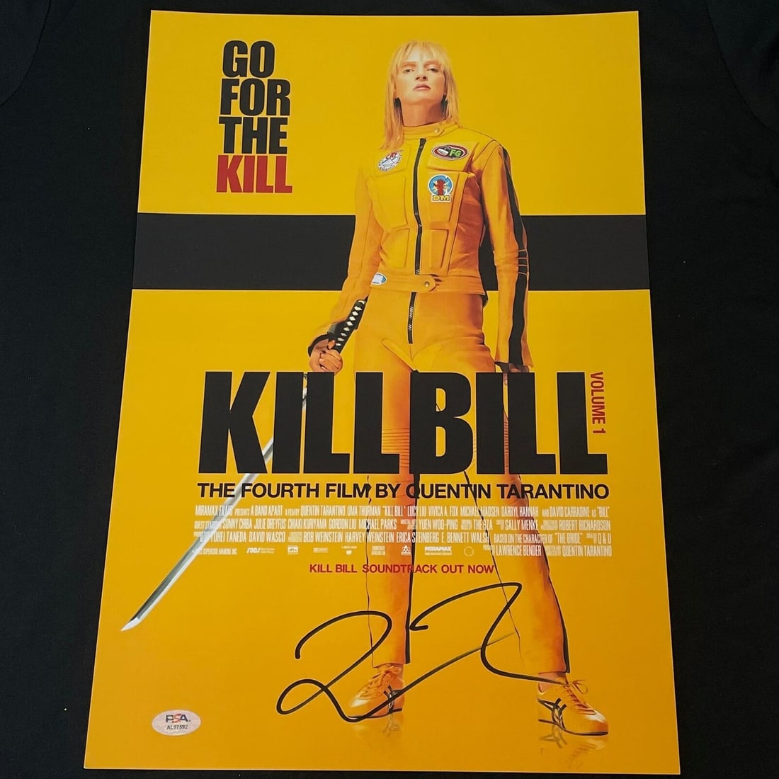 Quentin Tarantino Signed 12x18 Photo PSA/DNA: Quentin Tarantino Signed 12x18 Photo PSA/DNA This is an original 12x18 photograph from the film 'Kill Bill Volume 1', featuring a character in a yellow jumpsuit holding a sword. The photograph is sign