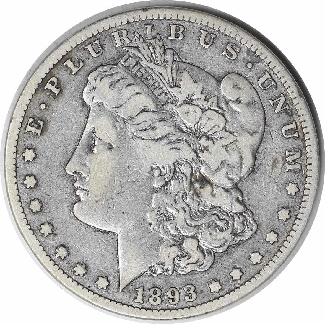1893-CC Morgan Silver Dollar VF Circulated: 1893-CC Morgan Silver Dollar VF Circulated This 1893-CC Morgan Silver Dollar showcases the exquisite craftsmanship of designer George T. Morgan. Featuring a profile of a woman with a headdress, this c
