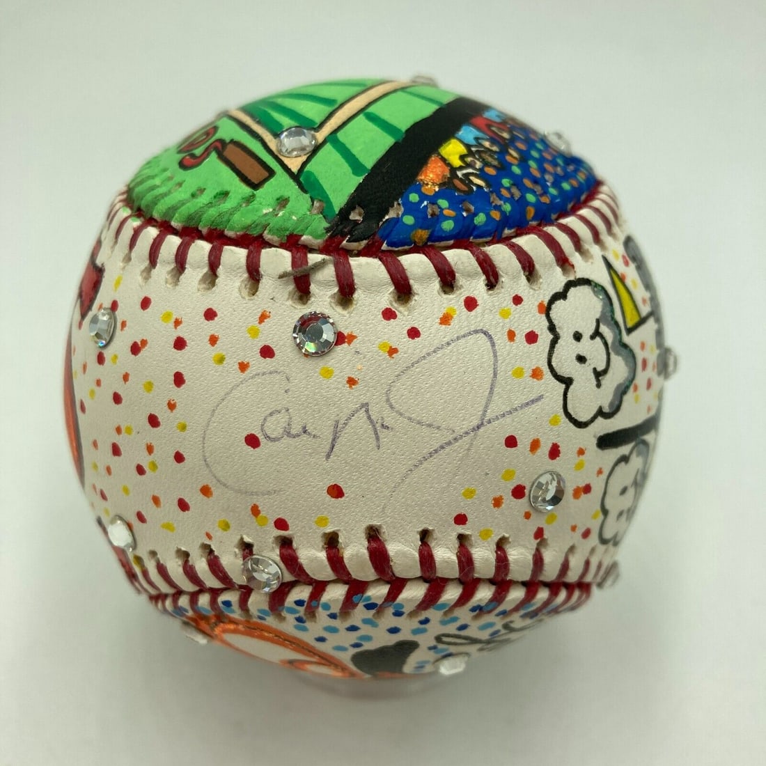 Cal Ripken Jr. Autographed Baseball by Charles Fazzino with Swarovski Crystals Steiner COA: Cal Ripken Jr. Autographed Baseball by Charles Fazzino with Swarovski Crystals Steiner COA Celebrate the legacy of baseball with this stunning Cal Ripken Jr. autographed baseball, featuring a unique h