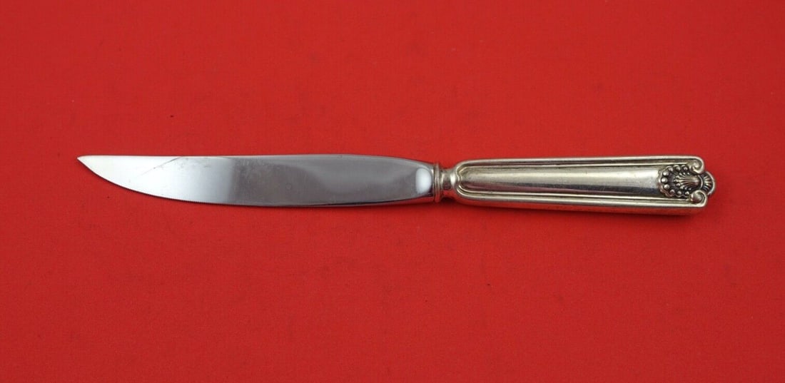 Frank Smith Fiddle Shell Sterling Silver Steak Knife 8 Inch: Frank Smith Fiddle Shell Sterling Silver Steak Knife 8 Inch This exquisite steak knife features the elegant Fiddle Shell pattern by Frank Smith, crafted from high-quality sterling silver. The knife bo