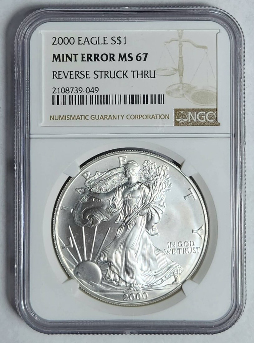 2000 P Silver Eagle NGC MS-67 Reverse Struck Thru Mint Error: 2000 P Silver Eagle NGC MS-67 Reverse Struck Thru Mint Error This stunning 2000 P Silver Eagle coin is graded MS-67 by NGC, showcasing its exceptional quality and detail. It features a unique mint err