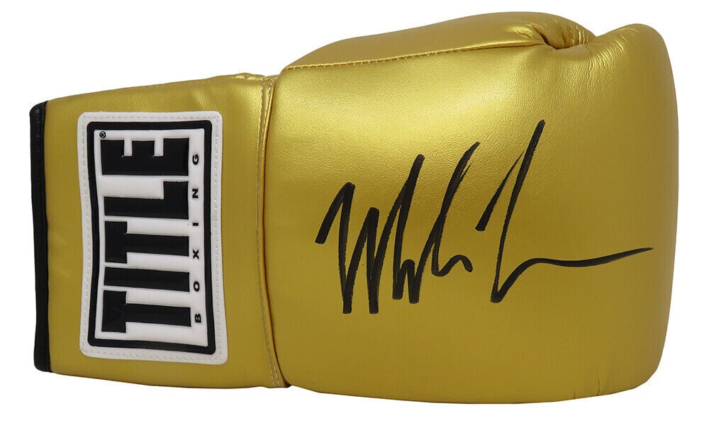 Mike Tyson Signed Title Gold Boxing Glove with Hologram COA: Mike Tyson Signed Title Gold Boxing Glove with Hologram COA Own a piece of boxing history with this Mike Tyson signed Title gold boxing glove. This original item features a pristine signature from the