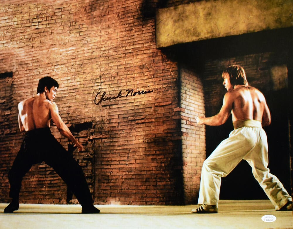 Chuck Norris Autographed 16x20 Photo The Way of the Dragon JSA: Chuck Norris Autographed 16x20 Photo The Way of the Dragon JSA This striking 16x20 photograph captures the intense stare down scene from the iconic movie 'The Way of the Dragon,' featuring the legenda