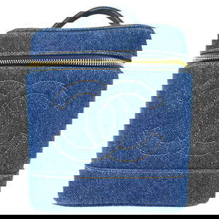 Chanel Vintage Indigo Denim Vanity Handbag 6x7x5 inches: Chanel Vintage Indigo Denim Vanity Handbag 6x7x5 inches This Chanel Vanity Handbag in indigo denim is a vintage piece that combines practicality with style. The bag features a classic blue exterior