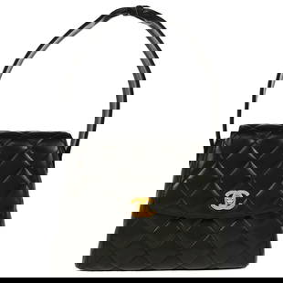 Chanel Black Lambskin Quilted Handbag with Turn Lock Closure: Chanel Black Lambskin Quilted Handbag with Turn Lock Closure This exquisite Chanel Black Lambskin Handbag is a statement of luxury and elegance. Crafted from premium lambskin leather, this small