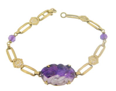 Art Deco 14k Yellow Gold Amethyst Bracelet GIA Certified Vintage: Art Deco 14k Yellow Gold Amethyst Bracelet GIA Certified Vintage This stunning Art Deco bracelet features a captivating design crafted from 14k yellow gold. It showcases a beautifully carved oval