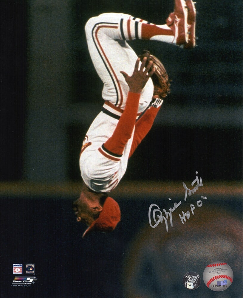 Ozzie Smith Signed Cardinals 8x10 Photo with HOF 02 Inscription: Ozzie Smith Signed Cardinals 8x10 Photo with HOF 02 Inscription Capture a piece of baseball history with this original signed 8x10 photo of Ozzie Smith in a dynamic flip action pose, showcasing his ex