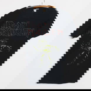 Vintage 1980 Iron Maiden Black Graphic T-Shirt 100% Cotton: Vintage 1980 Iron Maiden Black Graphic T-Shirt 100% Cotton Step back into the 1980s with this original vintage Iron Maiden shirt. This authentic piece features striking front and back graphics,