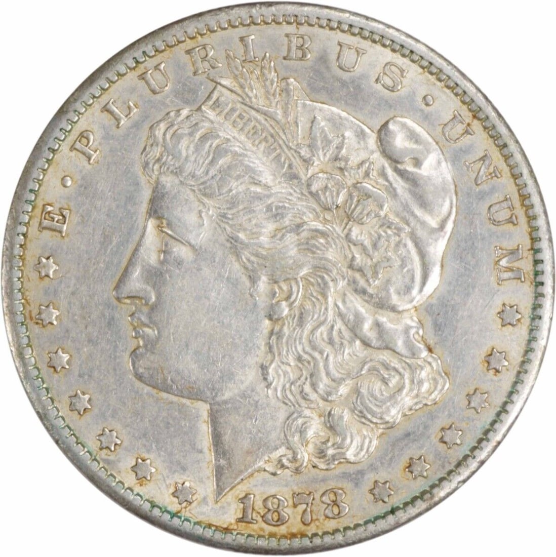 1878-CC Morgan Silver Dollar AU 90% Silver Coin by George T. Morgan: 1878-CC Morgan Silver Dollar AU 90% Silver Coin by George T. Morgan This 1878-CC Morgan Silver Dollar showcases a rich history and exquisite craftsmanship. Struck in Carson City, the coin features a c