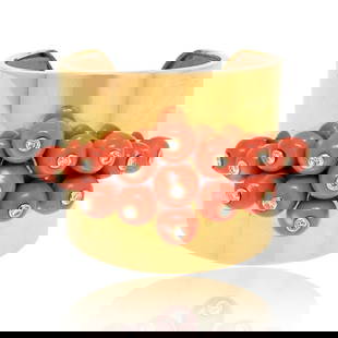 1960's 18K Yellow Gold Coral Diamond Cuff Bracelet 2 Cts: 1960's 18K Yellow Gold Coral Diamond Cuff Bracelet 2 Cts This exquisite Circa 1960's cuff bangle bracelet showcases a stunning design crafted from 18K yellow gold. Adorned with vibrant coral and spark