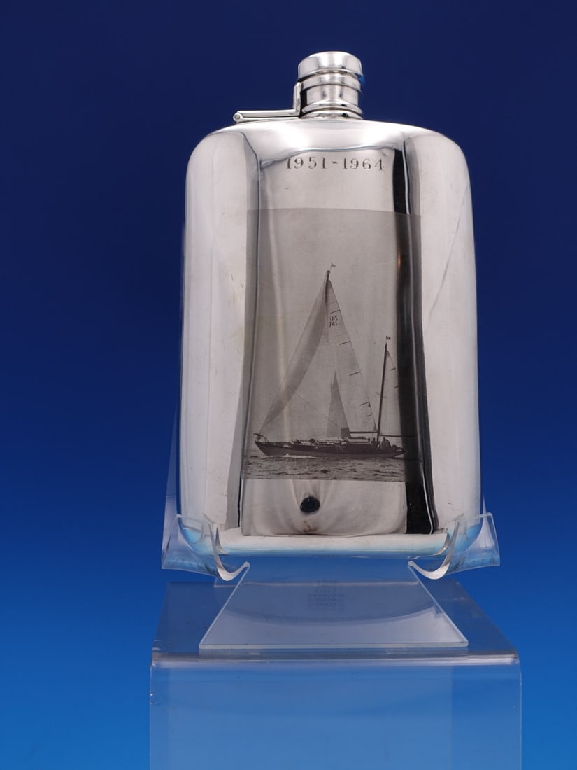 Tiffany & Co Sterling Silver Sailboat Flask 1 Pint 7.5": Tiffany & Co Sterling Silver Sailboat Flask 1 Pint 7.5" This exquisite Tiffany & Co. Sterling Silver Flask features a charming sailboat scene, making it a perfect collector's item or gift. Crafted fro