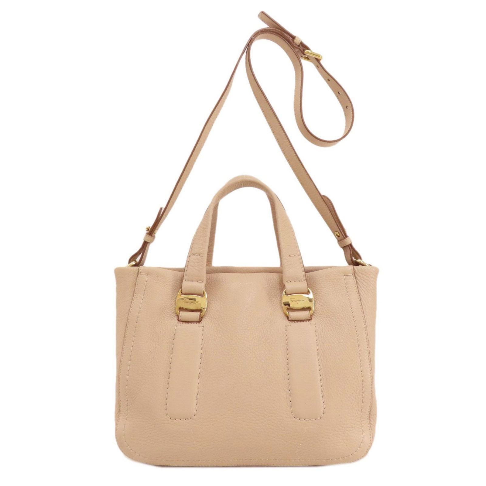 Salvatore Ferragamo Beige Leather Handbag with Metal Fittings 19cm x 30cm x 12cm: Salvatore Ferragamo Beige Leather Handbag with Metal Fittings 19cm x 30cm x 12cm This elegant handbag by Salvatore Ferragamo is crafted from high-quality leather in a sophisticated beige color. Design