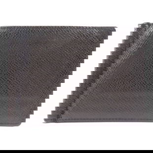 LOUIS VUITTON Taiga Leather Black Wallet with Money Clip M62978: LOUIS VUITTON Taiga Leather Black Wallet with Money Clip M62978 This LOUIS VUITTON wallet features a sleek design crafted from premium Taiga leather in classic black. The wallet showcases a money clip