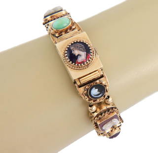 Vintage 14k Gold Slide Charms Bracelet with Hidden Watch and Gemstones: Vintage 14k Gold Slide Charms Bracelet with Hidden Watch and Gemstones Discover this exquisite vintage slide charms bracelet, expertly crafted from 14k yellow gold. This unique piece features a hidden