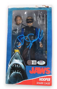 Steven Spielberg Signed JAWS Hooper Action Figure PSA Authenticated: Steven Spielberg Signed JAWS Hooper Action Figure PSA Authenticated This collectible action figure features a signature from renowned filmmaker Steven Spielberg, authenticated by Professional Sports A
