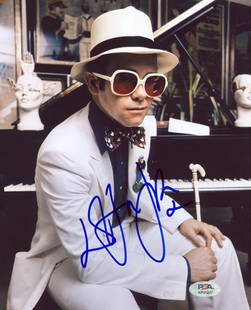 Elton John Signed 8x10 Photo PSA/DNA Certified Authentic: Elton John Signed 8x10 Photo PSA/DNA Certified Authentic This authentic autographed photograph features Elton John in a vertical sitting pose, measuring 8x10 inches. It has been personally signed by t