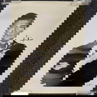 Roger Moore Signed 16x20 James Bond Photo Beckett Authenticated: Roger Moore Signed 16x20 James Bond Photo Beckett Authenticated This original 16x20 canvas photo features the iconic James Bond, portrayed by Roger Moore, and is signed by the actor himself. The autog