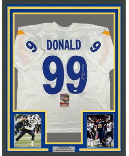 Framed Autographed Aaron Donald Los Angeles Rams Jersey JSA COA 35x39: Framed Autographed Aaron Donald Los Angeles Rams Jersey JSA COA 35x39 Enhance your collection with this framed autographed jersey of NFL star Aaron Donald. This authentic white jersey from the Los