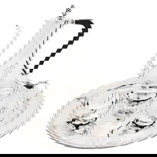 Four Piece Sterling Silver Tea Set: Four Piece Sterling Silver Tea Set This elegant four-piece sterling silver tea set, crafted by Tiffany & Co. in the late 1940s, features a teapot, creamer, sugar bowl, and tray. Each piece showcases t