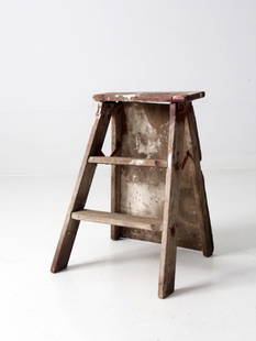 Vintage Rustic Wooden Step Ladder with Metal Hinges: Vintage Rustic Wooden Step Ladder with Metal Hinges This is a vintage wooden step ladder. The rustic ladder features two rung steps with a wooden board back brace and metal hinge closures. Remnants of