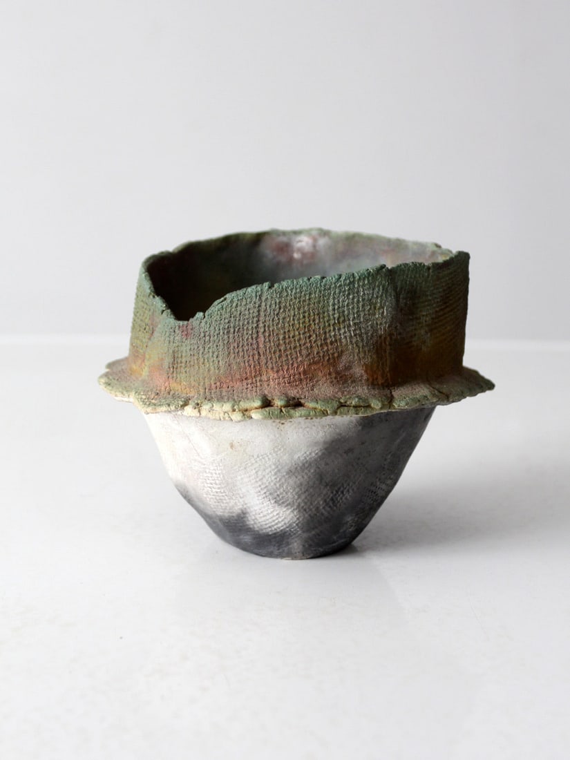 Handmade Vintage Studio Pottery Vase Wabi-Sabi Design: Handmade Vintage Studio Pottery Vase Wabi-Sabi Design This handmade pottery vase features an organic shape with an uneven rim and applied texture, embracing the Wabi-Sabi aesthetic. The earthy glaze i