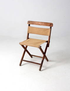 Vintage Folding Camp Chair Tan Canvas Red Metal Hardware: Vintage Folding Camp Chair Tan Canvas Red Metal Hardware This vintage folding camp chair combines practicality with rustic charm. Designed for versatility, it can function as both a stool and a chair,
