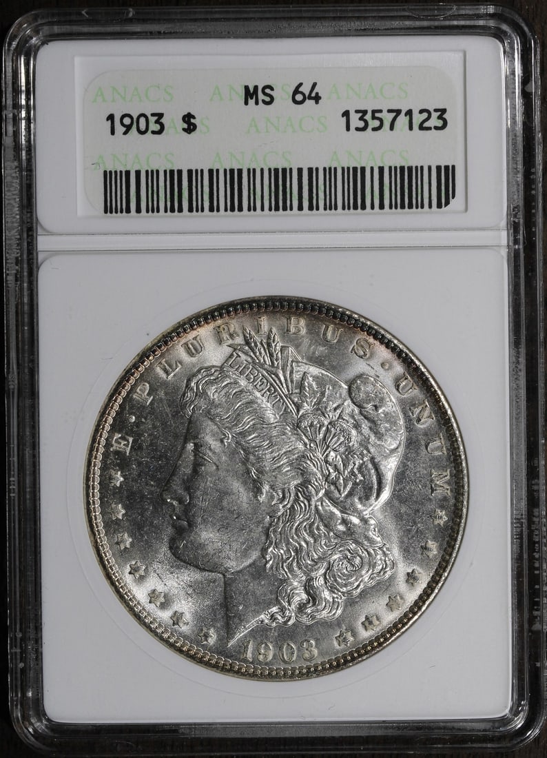1903 Morgan Silver Dollar MS64 ANACS Old Soapbox Holder: 1903 Morgan Silver Dollar MS64 ANACS Old Soapbox Holder This 1903 Morgan Silver Dollar is a stunning example of American numismatic history. Graded MS64 by ANACS, this uncirculated coin features a com