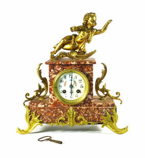 Classic Marble Mantle Clock with Cherub 13x12x4.75 inches: Classic Marble Mantle Clock with Cherub 13x12x4.75 inches Presenting a stunning Marble Mantle Clock featuring a large cherub atop its elegant design. This original piece showcases a beautiful red marb