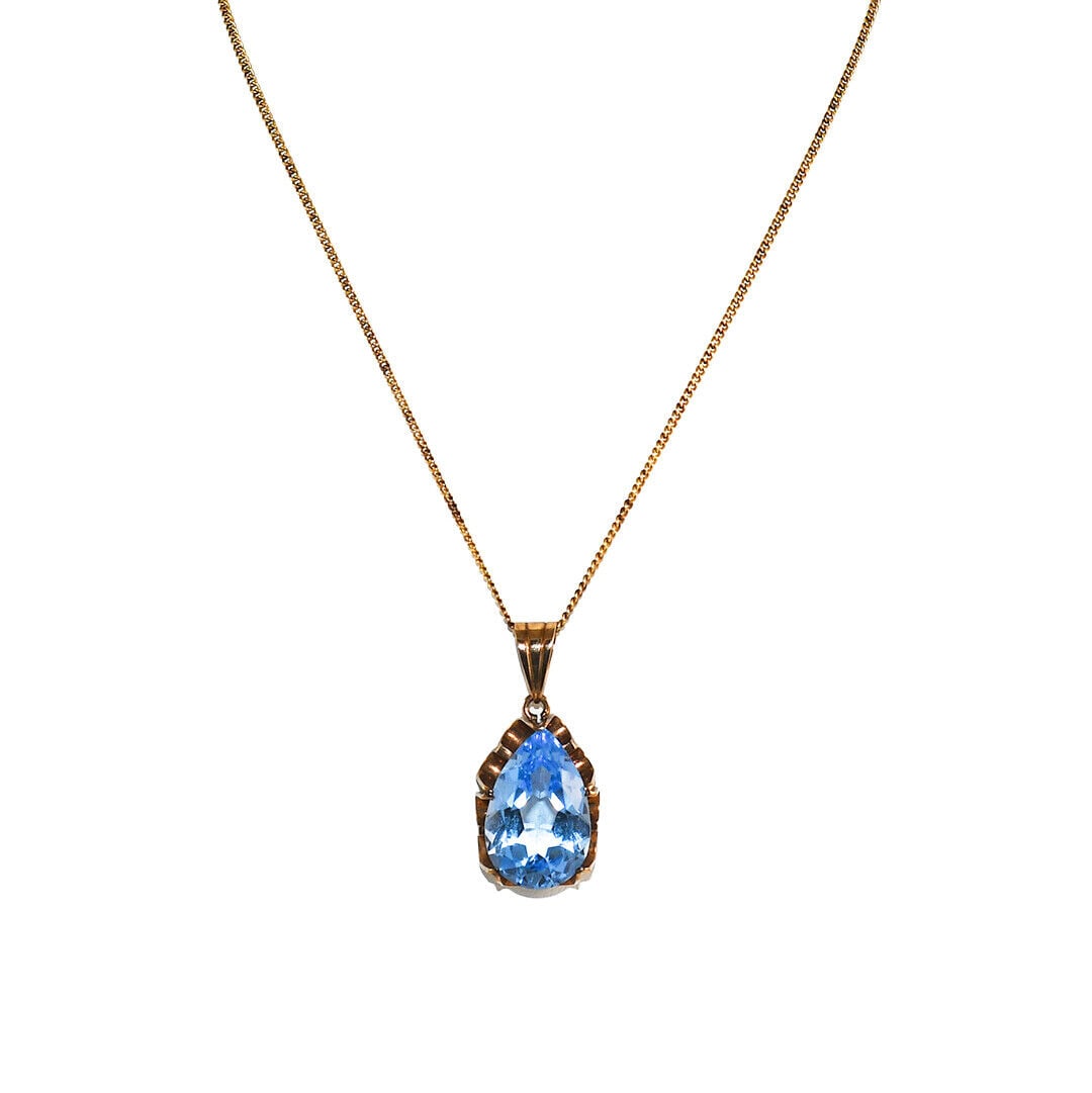 Vintage 14k Yellow Gold Blue Spinel Pendant Necklace 17 Inch: Vintage 14k Yellow Gold Blue Spinel Pendant Necklace 17 Inch This exquisite vintage pendant necklace features a stunning pear-shaped synthetic blue spinel, elegantly set in a 14k yellow gold setting. 