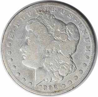 1892-CC Morgan Silver Dollar VG Uncertified 90% Silver Coin: 1892-CC Morgan Silver Dollar VG Uncertified 90% Silver Coin This 1892-CC Morgan Silver Dollar showcases the artistry of designer George T. Morgan. It is a circulated coin with a composition of 90%
