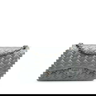 Chanel Jumbo Classic Lambskin Double Flap Silver Leather Shoulder Bag: Chanel Jumbo Classic Lambskin Double Flap Silver Leather Shoulder Bag Introducing the Chanel Jumbo Classic Lambskin Double Flap shoulder bag, exquisitely crafted from quilted lambskin leather. This