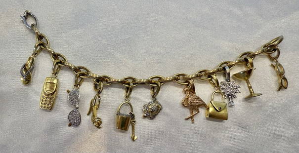 Roberto Coin 18K Gold Diamond Cuff Bracelet with 10 Charms and Pouch: Roberto Coin 18K Gold Diamond Cuff Bracelet with 10 Charms and Pouch This exquisite Roberto Coin charm bracelet showcases a stunning combination of 18K yellow and white gold, adorned with 10 beautiful
